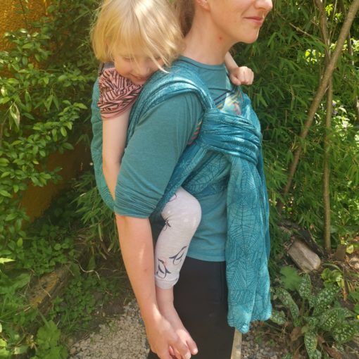 6 yr old in back carry hiving her toes tickled