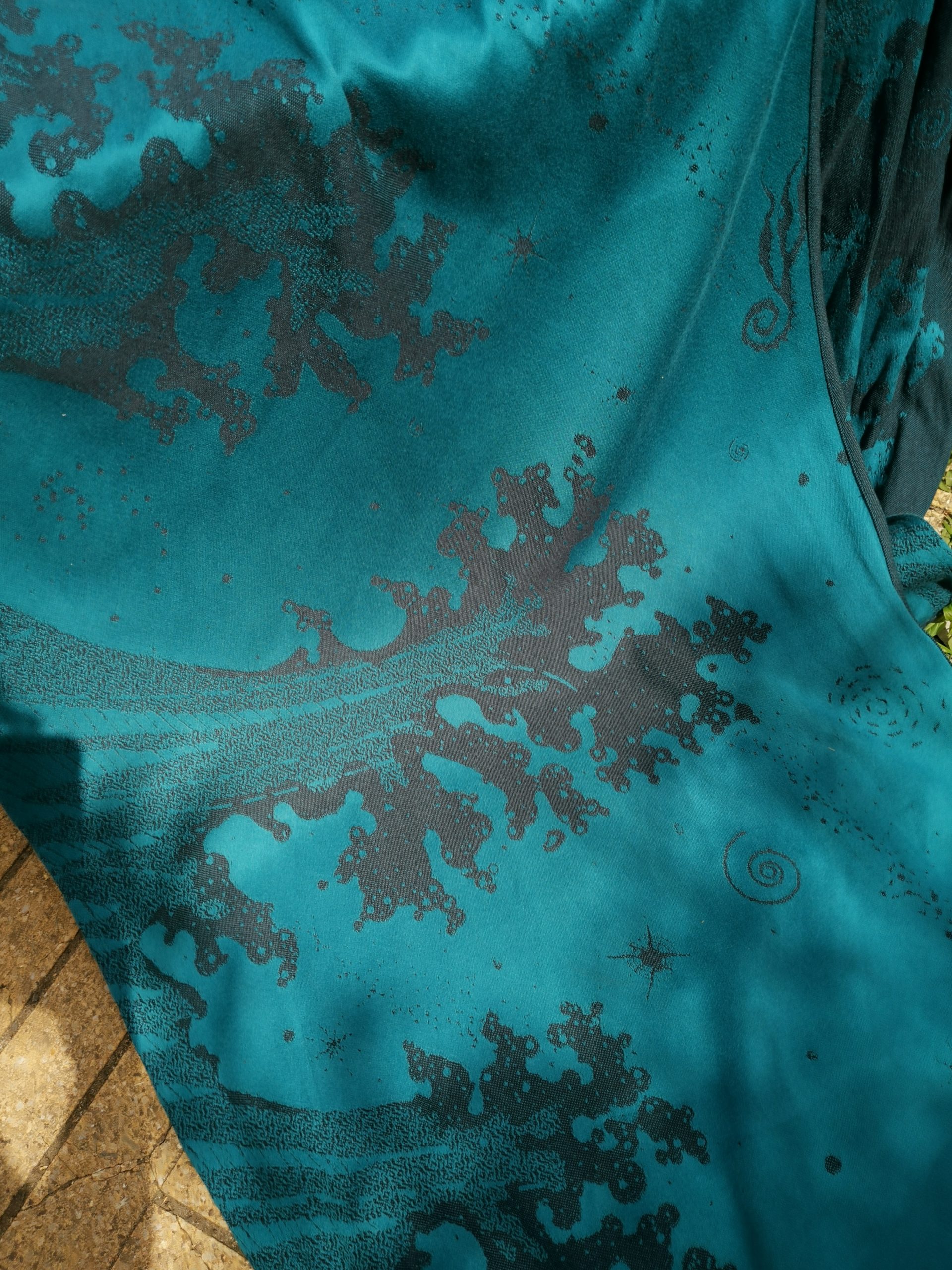 navy blue and teal jacquard woven fabric featuring crashing waves