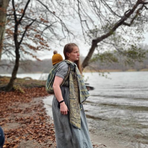 blue and green 100% organic cotton woven wrap tied in a back carry