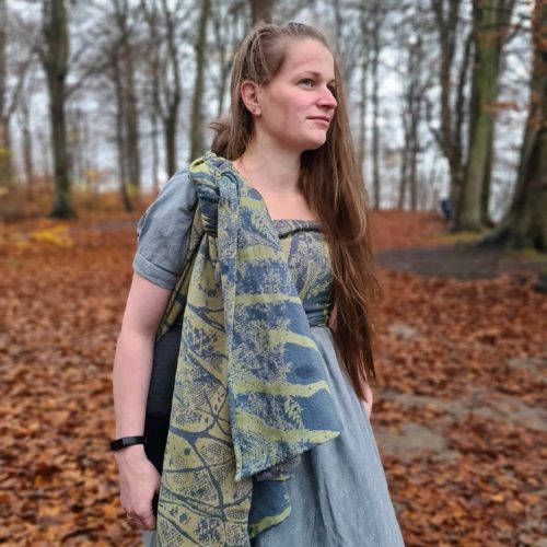 blue and green 100% organic cotton woven wrap tied in a back carry (double hammock tied at shoulder (DHTAS))