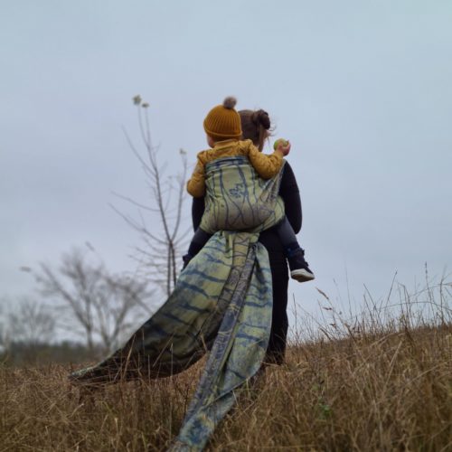 blue and green 100% organic cotton woven wrap tied in a back carry