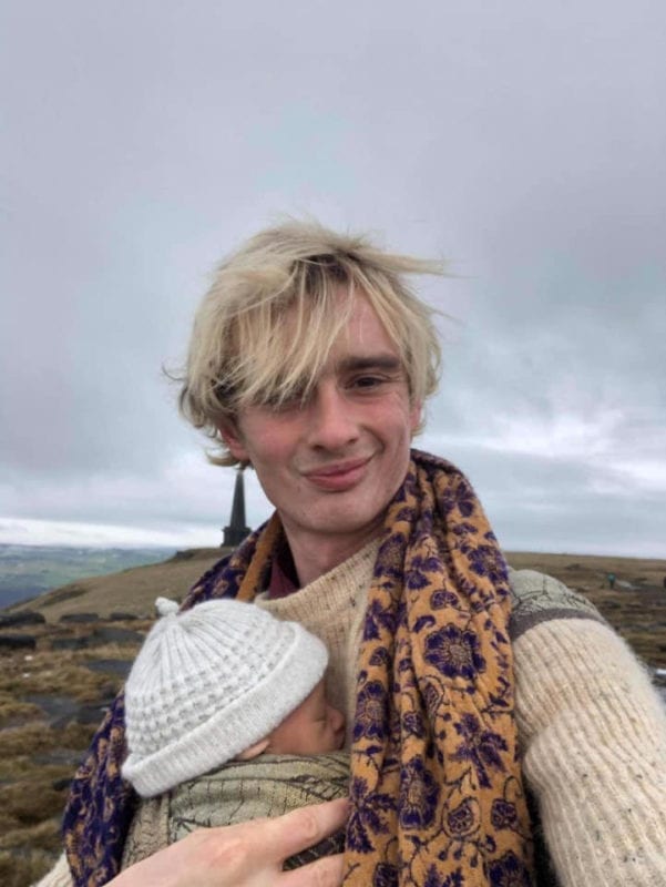 dad newborn babywearing in a woven wrap