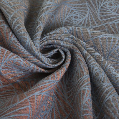 A woven wrap with a geometric design in a gradient of russet and brown shimmery linens against a grey-blue cotton