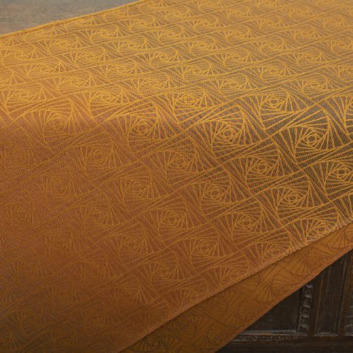 woven wraps feature a geometric design in a shimmery gradient of russet and brown supersoft linens against warm mustard-gold cotton for understated elegance