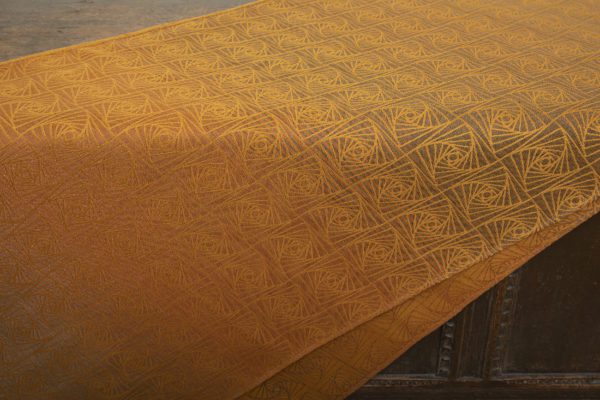 woven wraps feature a geometric design in a shimmery gradient of russet and brown supersoft linens against warm mustard-gold cotton for understated elegance