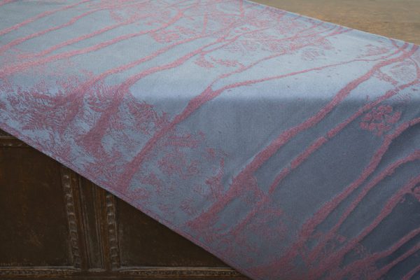 A woven wrap made from fluffy pink-grey merino wool and a cool grey-blue cotton into our birch trees design