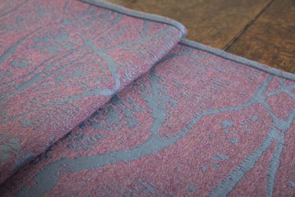 A woven wrap made from fluffy pink-grey merino wool and a cool grey-blue cotton into our birch trees design