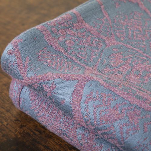 A woven wrap made from fluffy pink-grey merino wool and a cool grey-blue cotton into our birch trees design