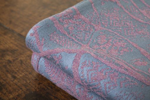 A woven wrap made from fluffy pink-grey merino wool and a cool grey-blue cotton into our birch trees design
