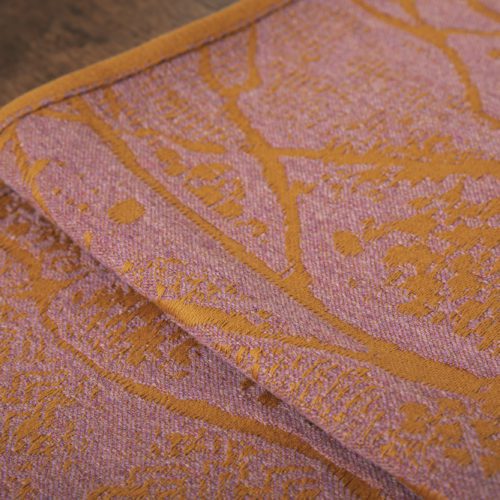 A woven wrap made from fluffy pink -grey merino wool and golden mustard cotton in a birch trees design