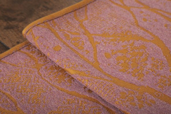 A woven wrap made from fluffy pink -grey merino wool and golden mustard cotton in a birch trees design