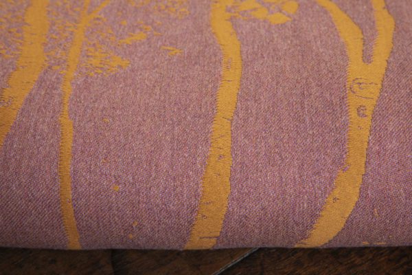 A woven wrap made from fluffy pink -grey merino wool and golden mustard cotton in a birch trees design